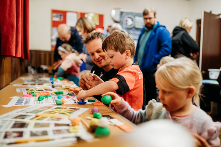 An image of children playing with modelling clay. 